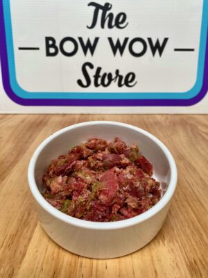 Bowl of human grade dog food which contains duck, rabbit, Quail, Venison and kangaroo meat, duck offal, bone content and mixed vegetables